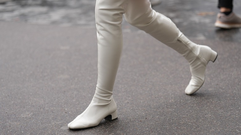 woman wearing white leather boots