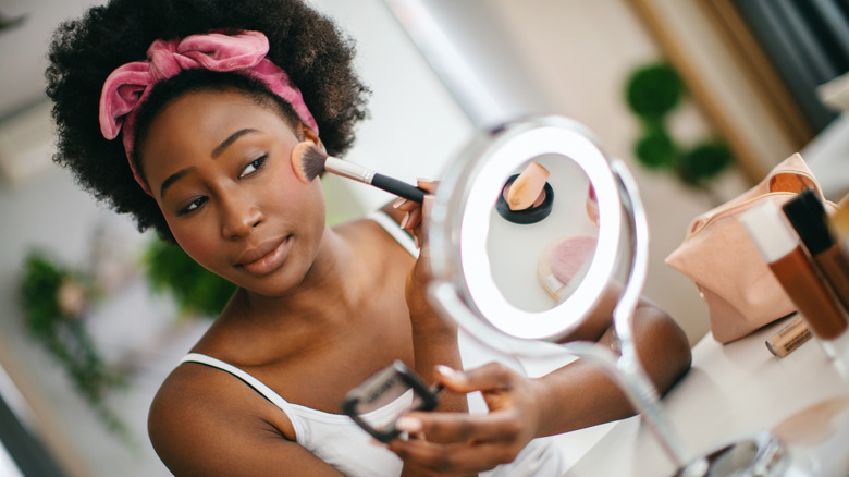 woman applying blush