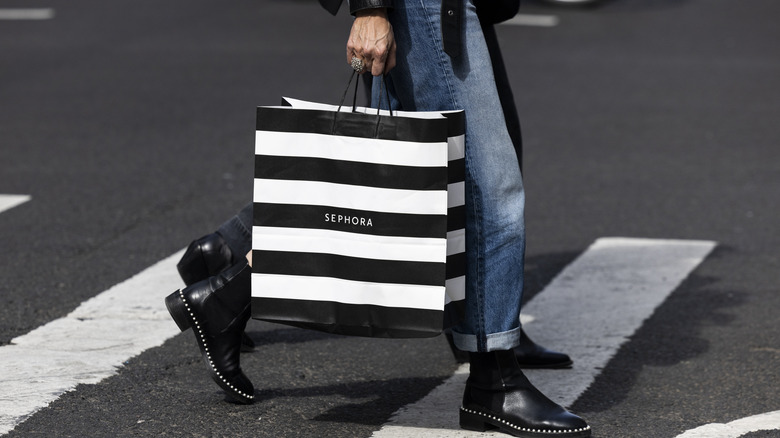 Woman walking with Sephora bag