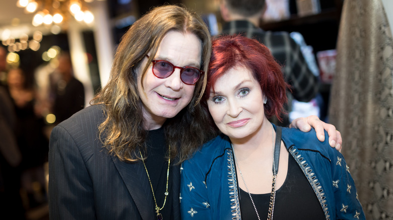 Ozzy Osbourne with his arm around Sharon Osbourne