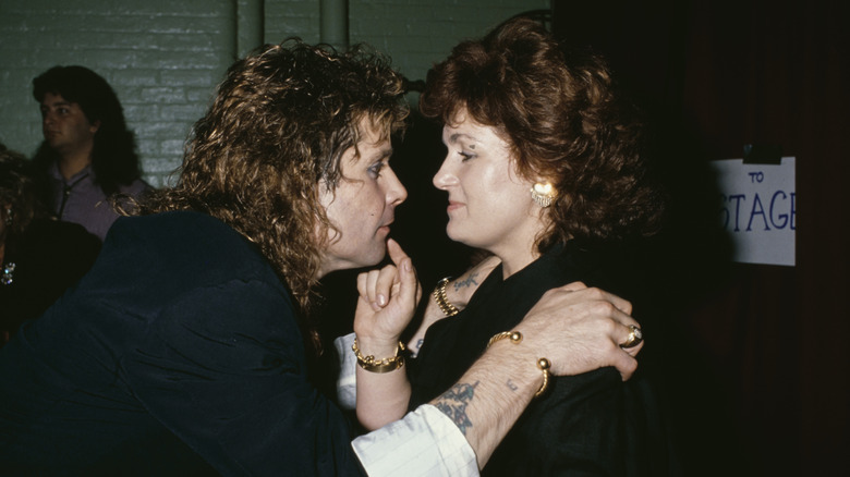 Ozzy Osbourne and Sharon Osbourne looking at each other