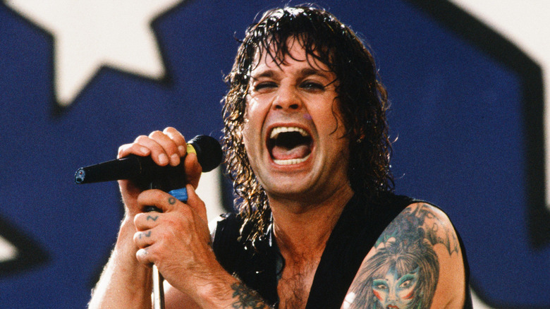 Ozzy Osbourne singing to a microphone