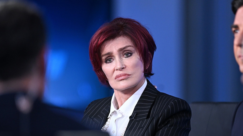 Sharon Osbourne sits at a desk during a panel interview