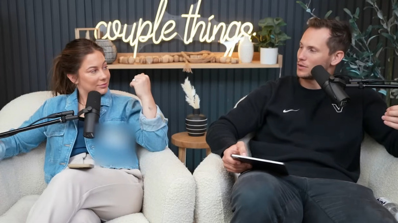 Shawn Johnson and Andrew East looking at each other on their podcast