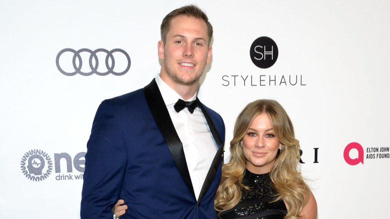 Andrew East and Shawn Johnson smiling at a red carpet