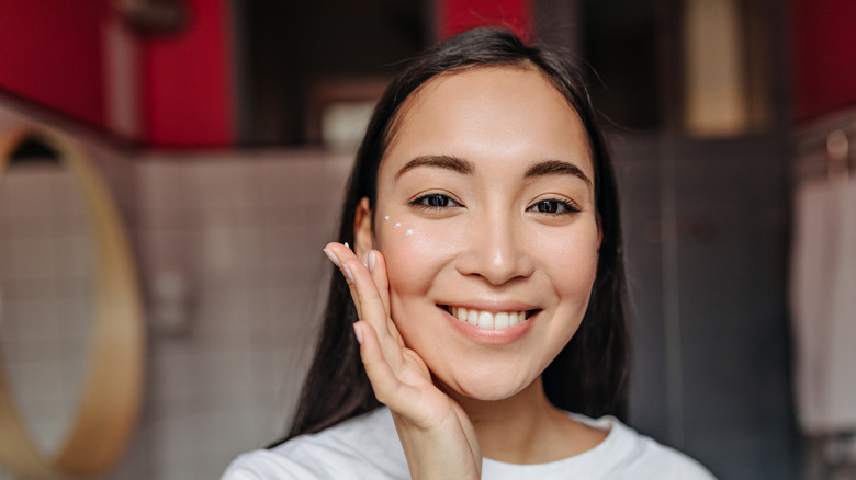 woman getting concealer applied