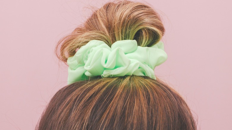 hair scrunchie in woman's bun 