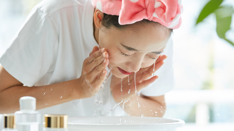 woman washing her face