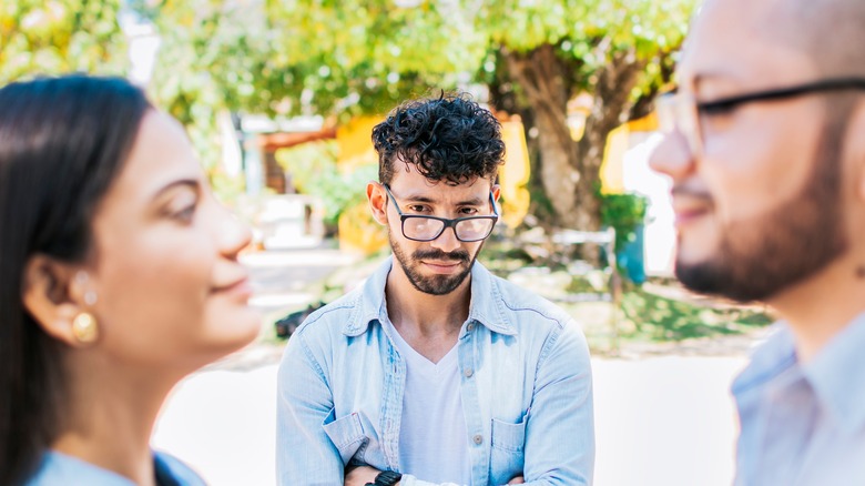 man looking at man and woman