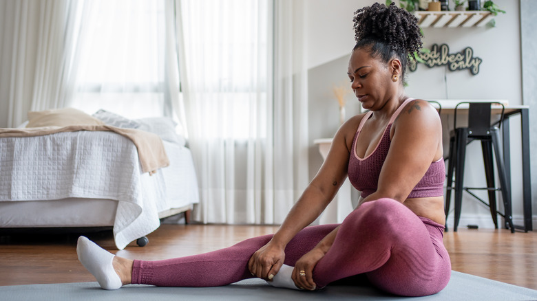 woman stretching at home