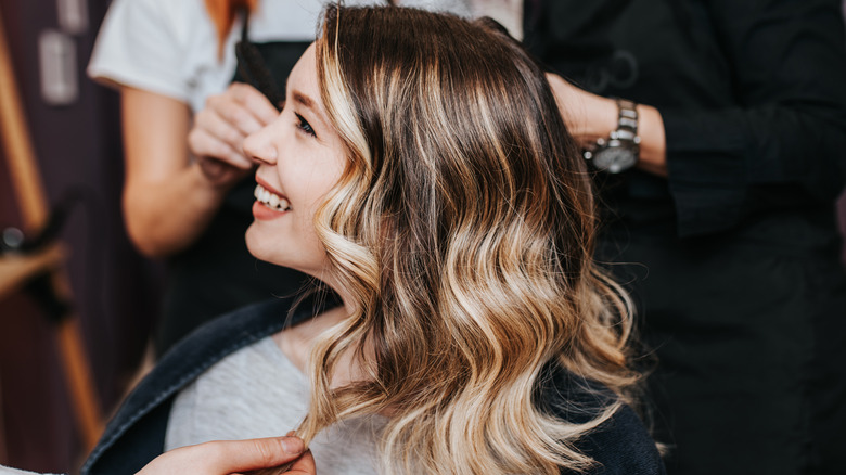 female at a salon with balayage hair