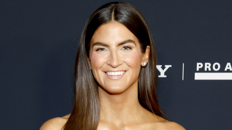 Kaitlan Collins posing at a 2026 event in a black dress