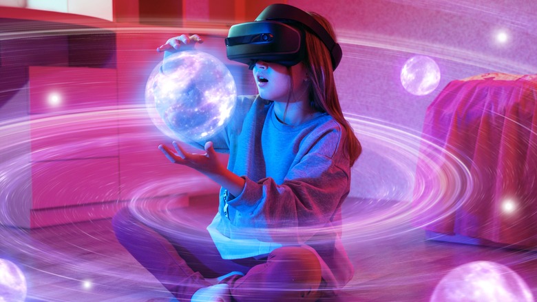 girl playing with virtual planets