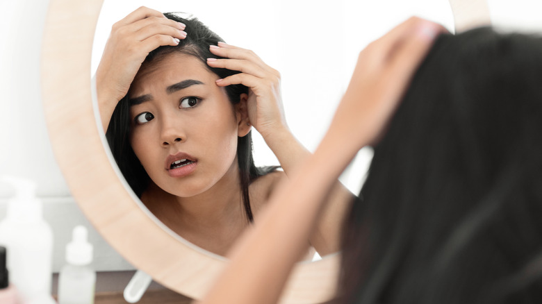 woman checking her scalp