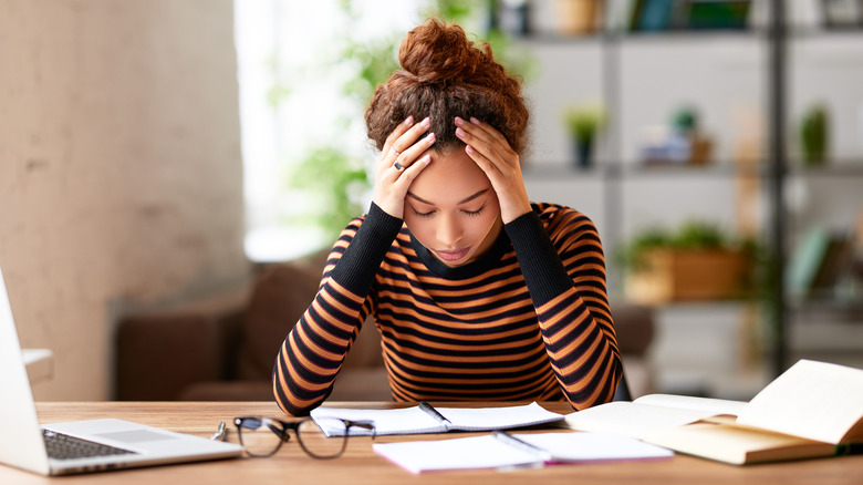 Woman looking stressed at desk