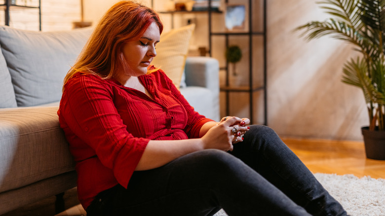 woman overwhelmed sitting on floor