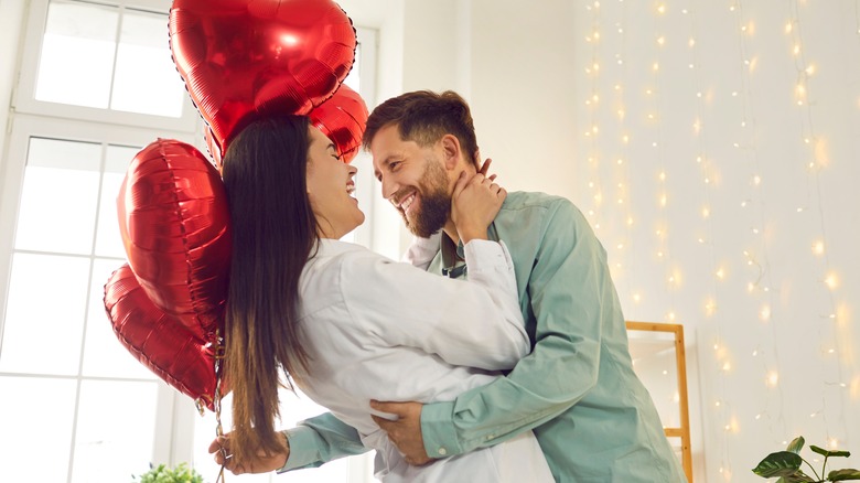 A couple smiling and embracing