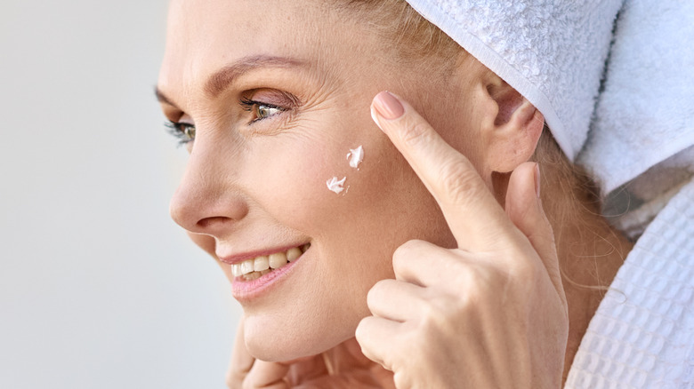 female apply face cream