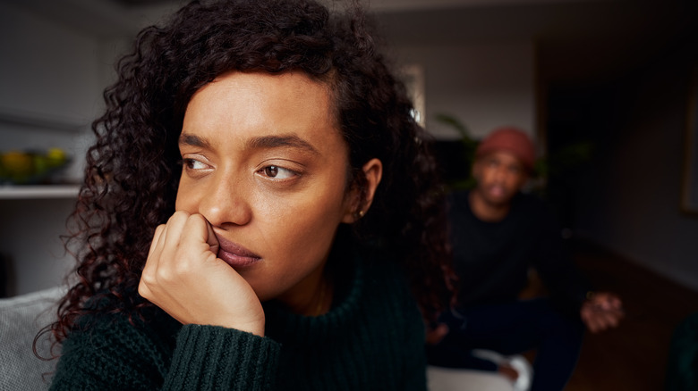 Woman thinking, ignoring man