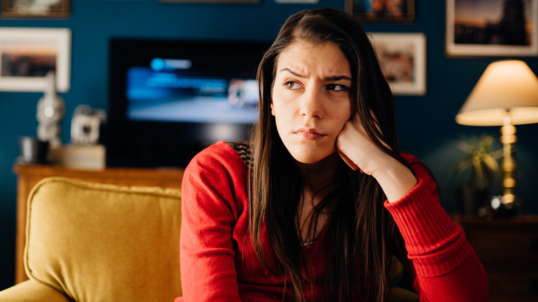 Cynical woman in her living room 