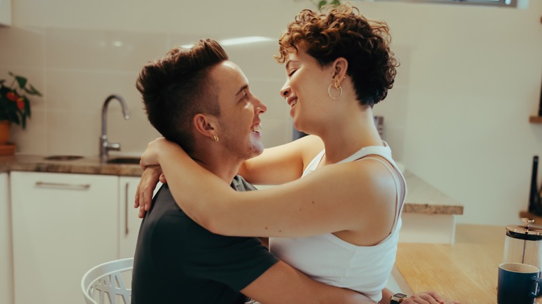 couple in kitchen hugging