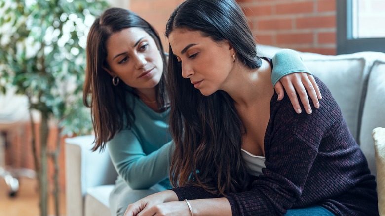 Woman comforts troubled friend