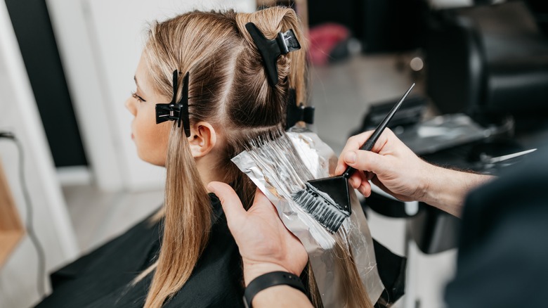 woman getting hair dyed