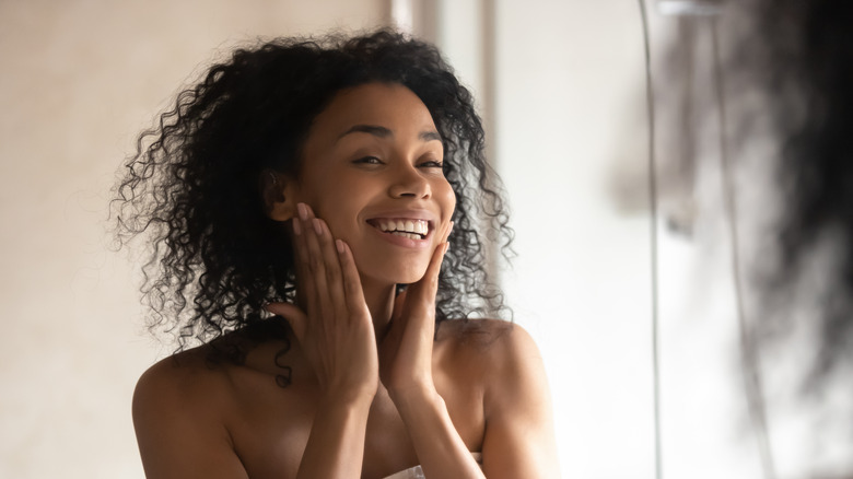 Woman admires skin in mirror