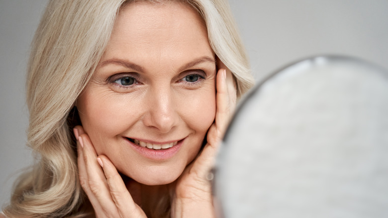 woman looking in mirror