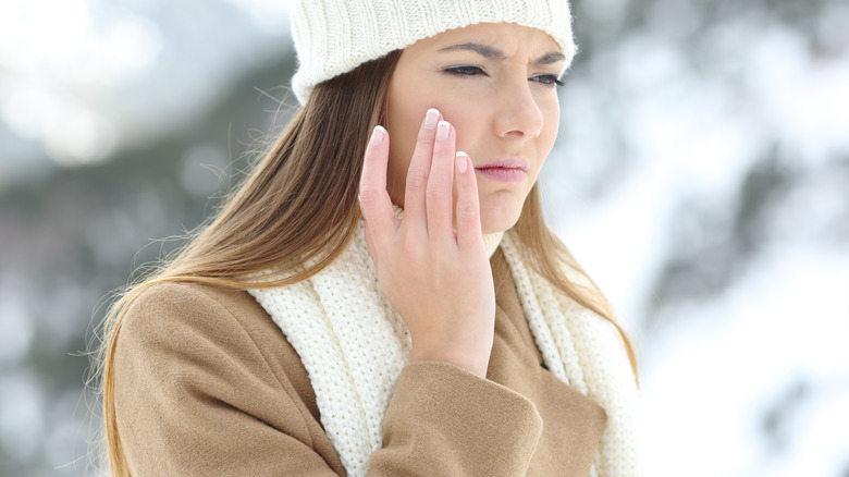 Woman touching her face in the cold