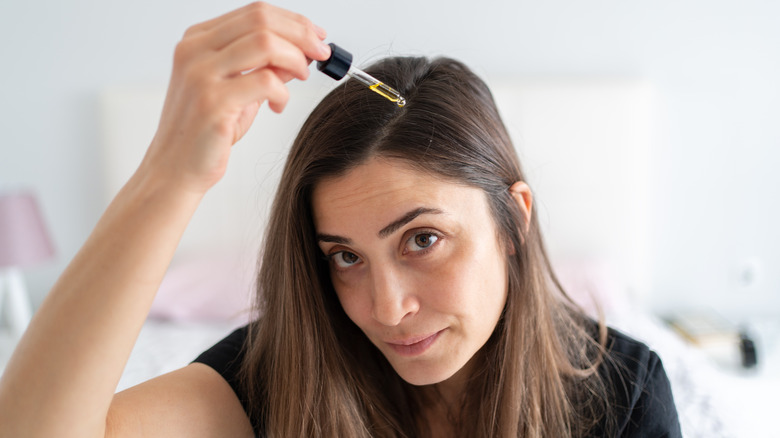 Woman using a hair serum