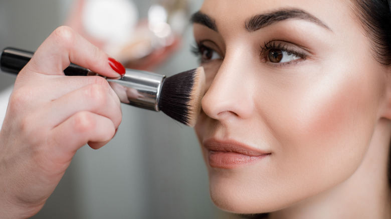 Woman having her makeup done