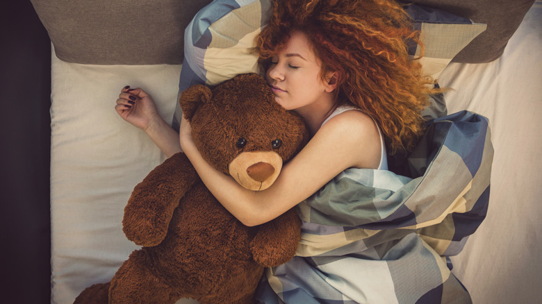 Woman hugging stuffed animal