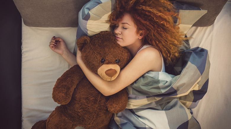 Woman hugging stuffed animal