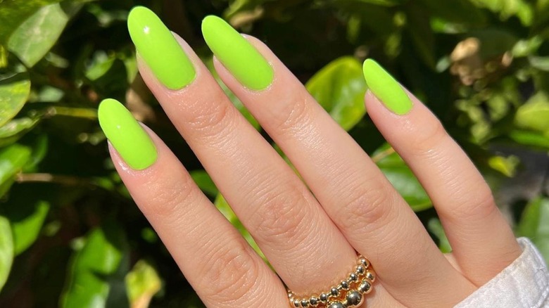 Woman wearing slime green nails