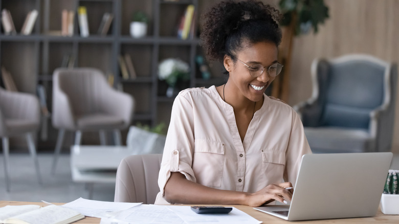 smiling woman using computer