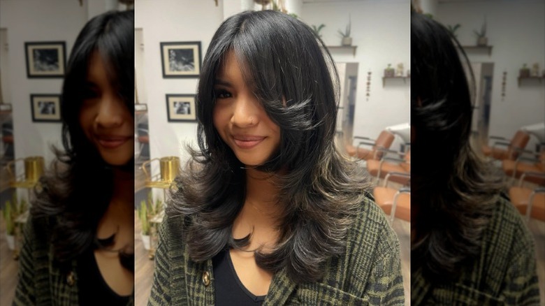 Woman with ashy brown curtain bangs