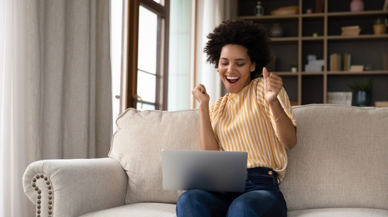 Happy woman looking at computer