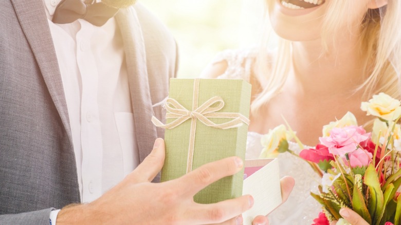 Bride and groom opening present