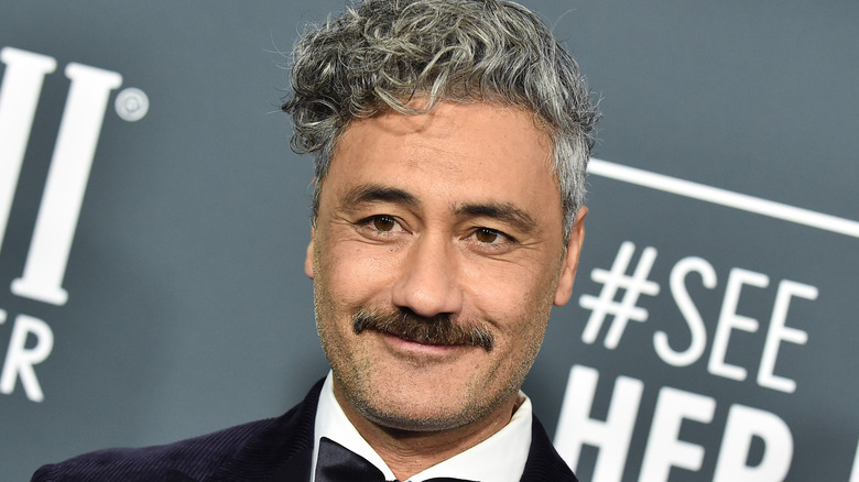 taika watiti with closed-mouth smile