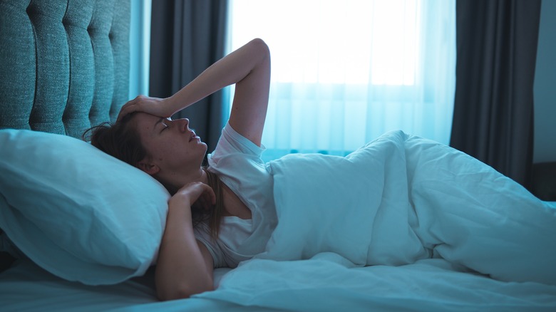 Woman struggles to wake up in bed