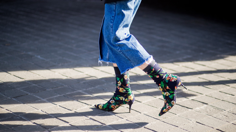 woman wears floral sock boots
