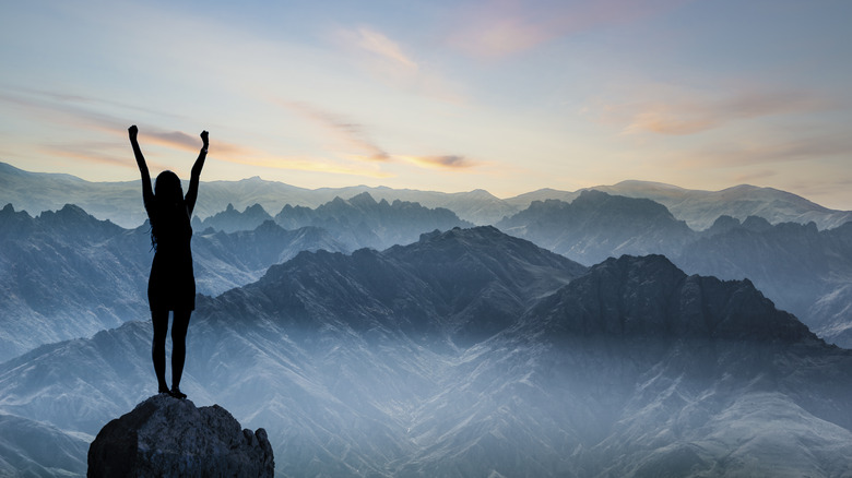 Woman on top of mountain