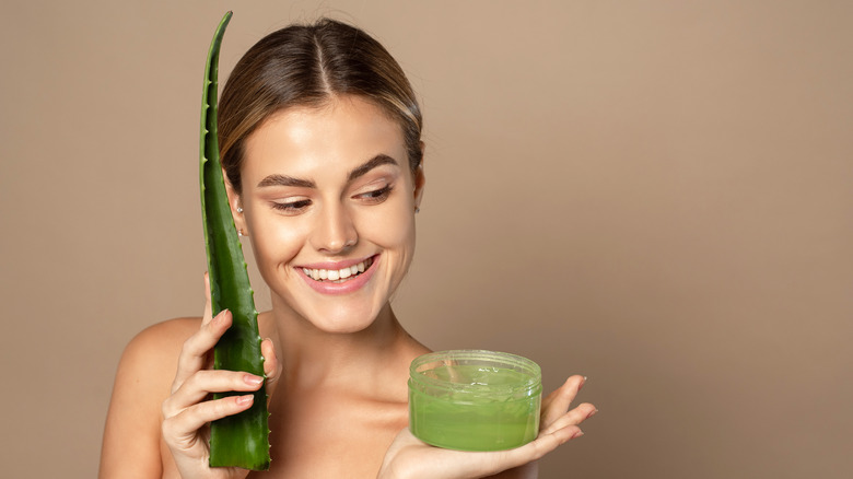 woman holding aloe vera