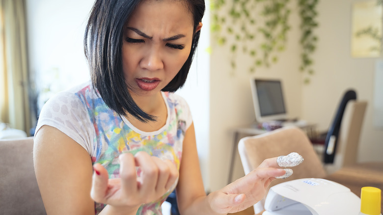 person applying nail glue 