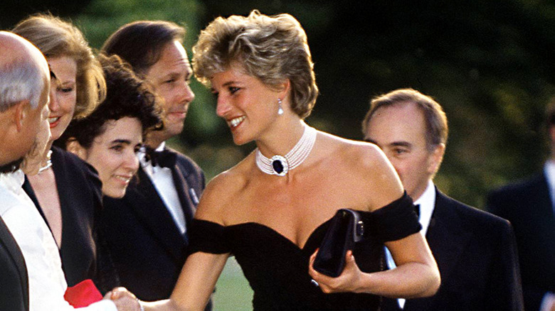 Princess Diana photographed wearing her 1994 revenge dress with ornate jewelry.