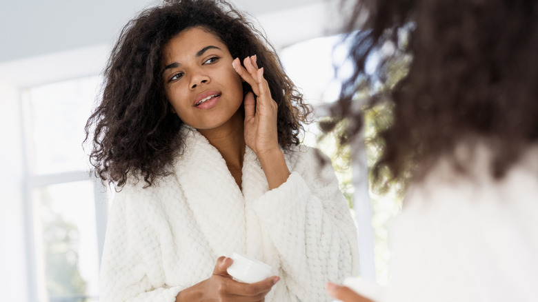 Woman applying face cream