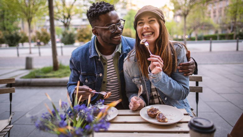 multiracial couple enjoying lunch outdoors