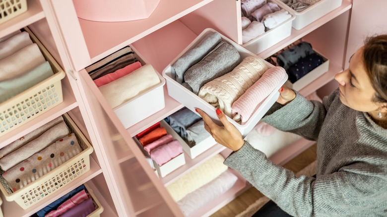 woman organizing pink closet