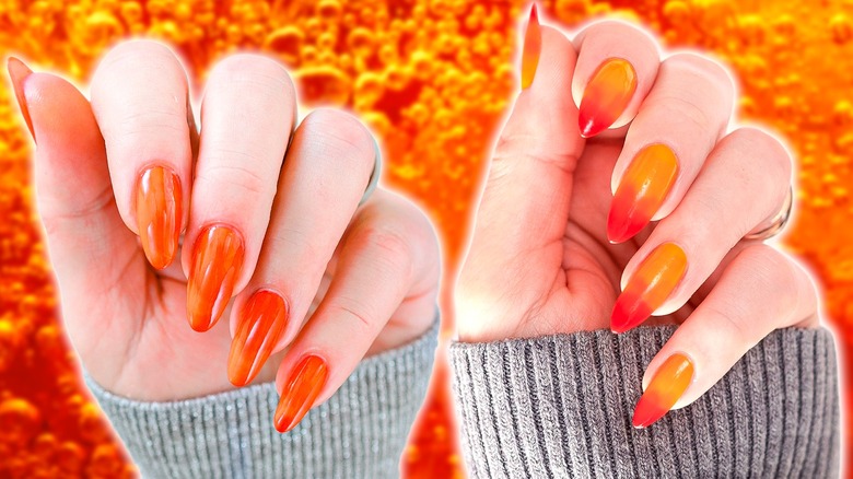 two hands with orange nails